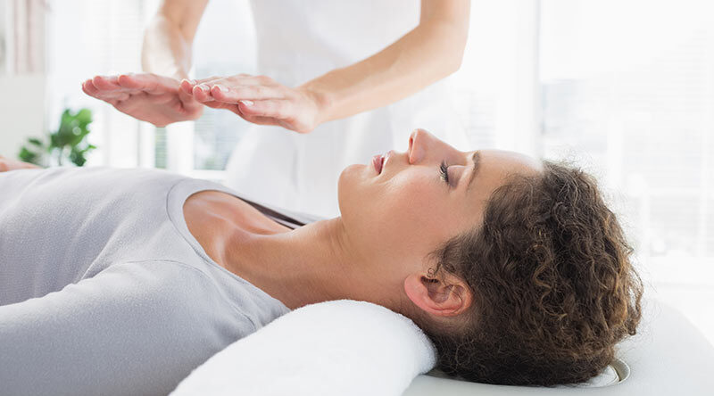 Woman having reiki treatment